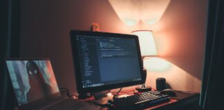 Kultowe silniki graficzne które zmieniły oblicze gier na zawsze Ciepło oświetlone domowe biuro z dwoma monitorami do programowania